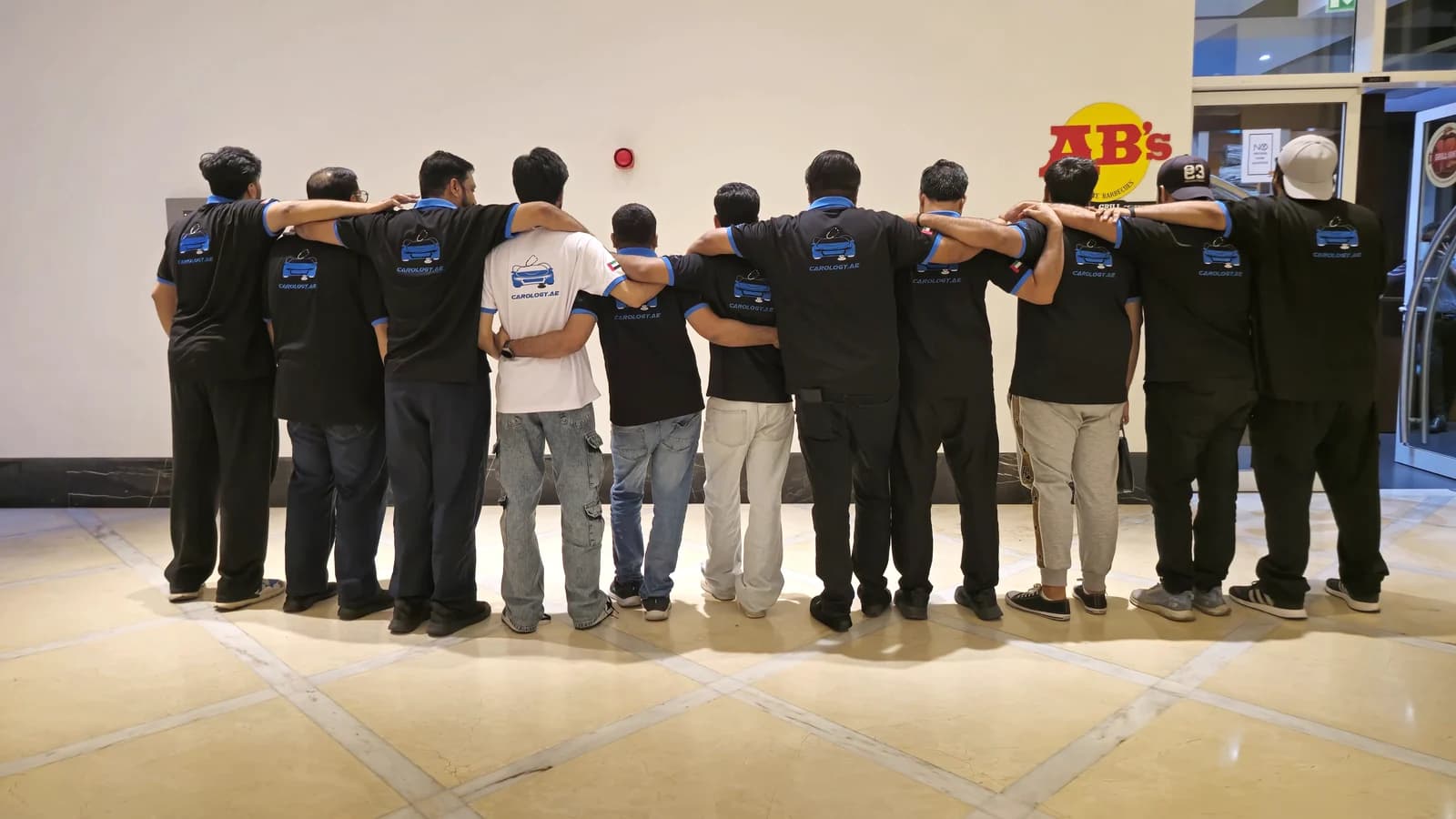 The Carology team in their branded shirts at the Business Bay office in Dubai